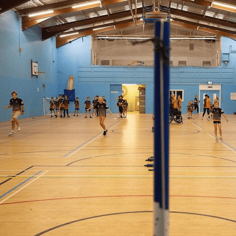 Net Ninjas juniors playing badminton at Broadclyst Sports Hall