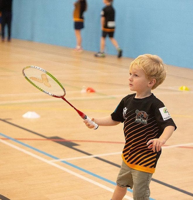 A young Net Ninjas player mid-shot at a training session