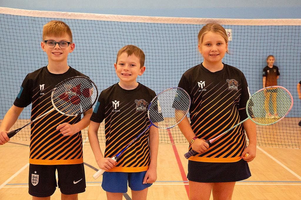 Net Ninjas player leadership team: Joshua, Josie and Oscar with their rackets on court